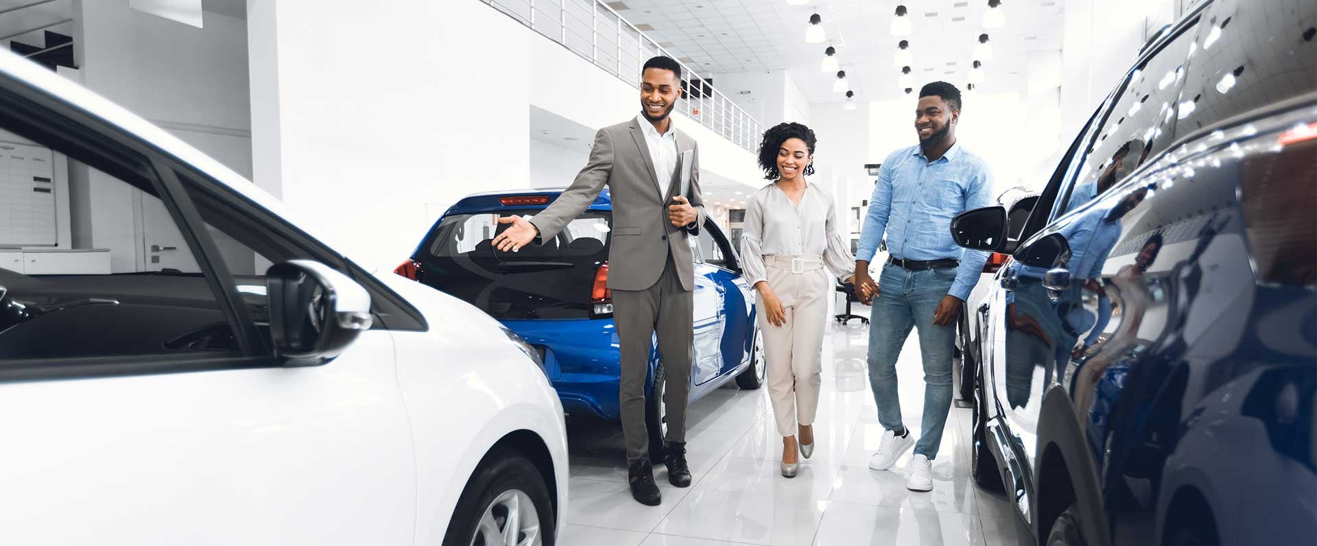 couple and salesman in dealership